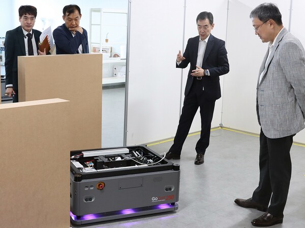 임장혁 LG유플러스 기업신사업그룹장(사진 오른쪽)이 유진로봇의 '고카트250'의 시연 및 설명을 듣고 있는 모습. [사진=LG유플러스 제공]